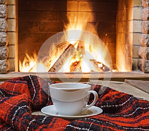 Relax with cup of tea before cozy fireplace.