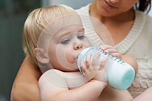Relax, cute and baby drinking bottle and laying with mother with milk for bonding together. Growth, sweet and infant