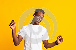 Relax and dance. Handsome young african man listening to music