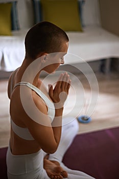 Relax exercising in lotus pose with candles at home