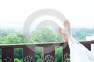 Relax feet of young woman lying on soft mattress. photo