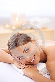 Relax, happy and portrait of woman at spa with body massage for health, wellness and self care. Smile, natural and