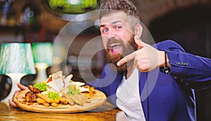 Relax after hard day. Businessman formal suit sit at restaurant. Man received meal with fried potato fish sticks meat