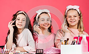 Relax and having fun. small girls in beauty salon. little sisters in retro fashion headscarf. makeup for kids. group of
