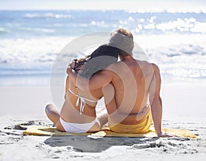 Relax, hug and couple on beach for holiday adventure together on tropical island with towel from back. Love, man and