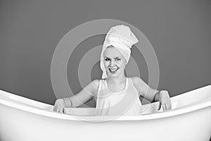 Relax and hygiene, woman with towel turban in white bathtub