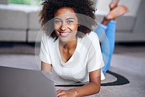 Relax, laptop and portrait of woman on floor working on freelance creative project in living room. Happy, technology and