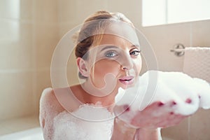 Relax and let your worries just soak away. Portrait of an attractive young woman relaxing in the bathtub.