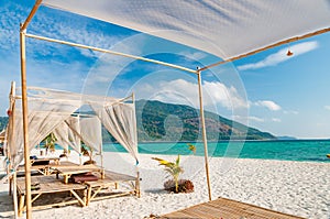 Relax on a luxury VIP beach with nice pavilions in a sunshine bl