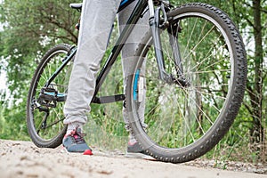 Relax on a mountain bike ride along the forest path. Sports and the concept of active life in the summer. Horizontal frame