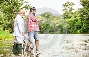 Relax in natural environment. Elegant bearded man and brutal hipster fishing. Family day. Fishing team. Friends fishing