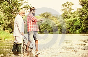 Relax in natural environment. Elegant bearded man and brutal hipster fishing. Family day. Fishing team. Friends fishing