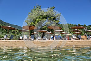 Relax on the nice beach with sun umbrellas and sun beds