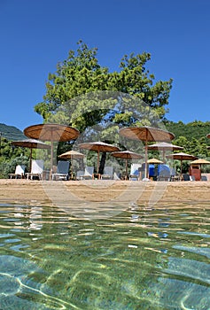 Relax on the nice beach with sun umbrellas and sun beds