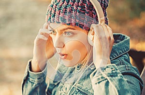 Relax in park. Hipster girl relax in park with mp3 player. Hipster woman in headphones relax in park. Listening music