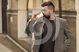 Relax and recharge. Man bearded hipster drinking coffee paper cup. One more sip of coffee. Drinking coffee on the go