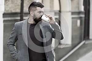 Relax and recharge. Man bearded hipster drinking coffee paper cup. One more sip of coffee. Drinking coffee on the go