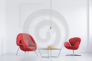 Relax room with red armchairs