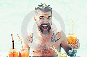 Relax at sea and spa resort. Cocktail party with bearded man in pool. Pool party with hipster in blue water. Man