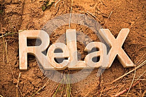 Relax Sign in on Sandy Beach by the sea