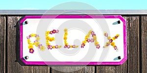 RELAX sign of yellow pink red and orange flowers collage, enamel, metal or pottery sign, wooden wall. frame, turquoise sky