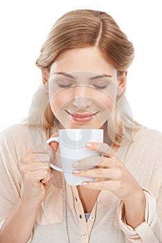 Relax, smile and woman with coffee in studio for break, aroma or peaceful moment on white background. Tea, face and