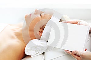 Relax in the spa. Beautiful woman beautifying the face cosmetic procedure. Beauty salon.