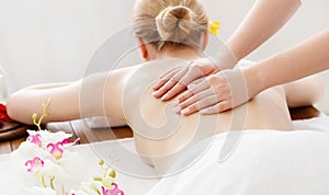 Relax and spa. Female hands on bare back girl on massage table