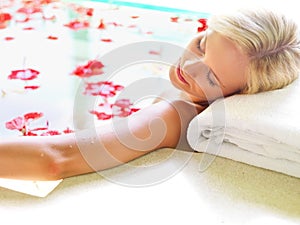 Relax, spa and flowers with woman in bath for skincare, aromatherapy or tropical vacation in Bali villa. Summer, beauty