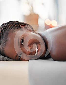 Relax, spa and portrait of black woman in massage bed for wellness, peace or luxury zen. Face, girl and resort for body