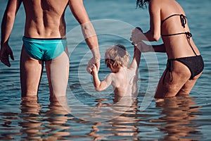 Relax in summer vacation. relax of young family with small boy in sea water.