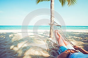 Relax and sunbathe on hammock at sandy tropical beach