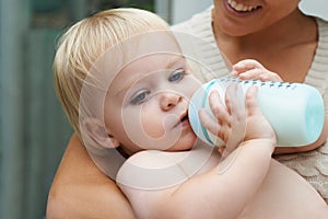 Relax, sweet and baby drinking bottle and laying with mother for milk and bonding together. Cute, growth and infant, kid
