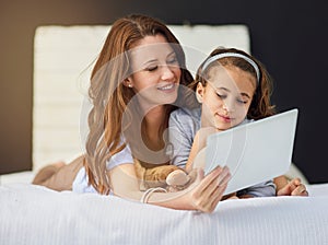 Relax, tablet and mom with girl on bed at home watch online video on app, internet or social media. Smile, love and