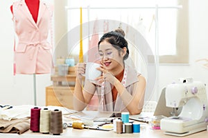 Relax time.  Asian women fashion designer  drinking coffee and  relax