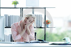 Relax time.  Successful Businesswoman relaxing  and resting after sitting and hard working in modern office.