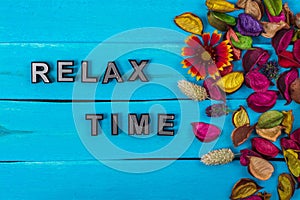 Relax time text on blue wood with flower