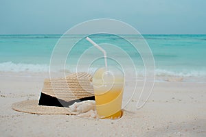Relax on a tropical island, concept. Protection from sun and heat. Straw hat and pineapple juice.