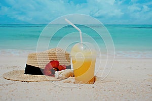 Relax on a tropical island, concept. Protection from sun and heat. Straw hat and pineapple juice