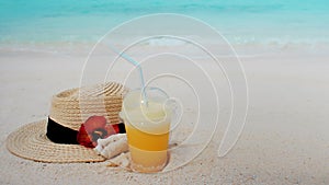 Relax on a tropical island, concept. Protection from sun and heat. Straw hat and pineapple juice