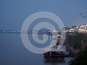 Relax  twilight background scene of evening sunlight on river bank with rural primitive country mood over smooth water surface at