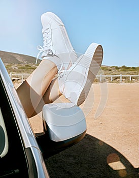 Relax, woman feet out of window and road trip in nature, enjoying freedom of travel in car on summer vacation. Blue sky