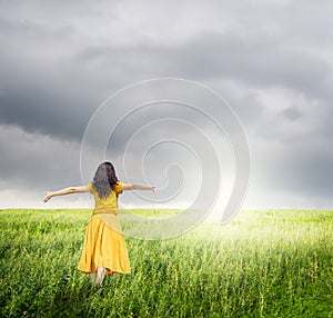 Relax Woman in green rice fields with rainclouds photo