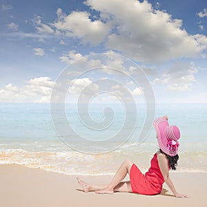 Relax Woman sitting on the beach and blue sky