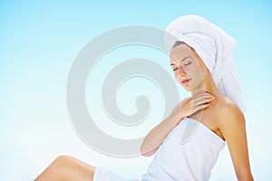 Relax, woman and spa towel outdoor with wellness, skincare and health treatment with blue sky. Mockup space, rest and