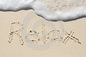 Relax Written in Sand on Beach