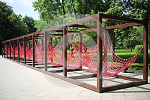 Relaxation area with red hammocks in the city photo