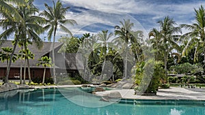 A relaxation area by the turquoise swimming pool.