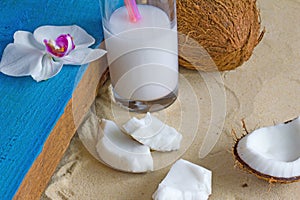 Relaxation at the beach with coconuts, coconut milk and orchid