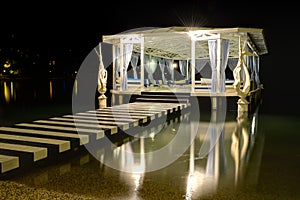 Relaxation building near beach in night illumination